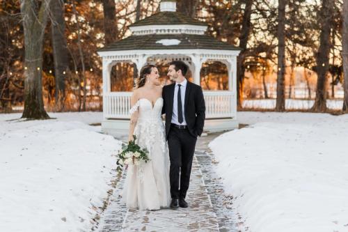 Bride and groom walking outdoors in winter at a wedding venue in Alberta 