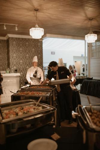 Staff serving food at an event held at the Norland Estate, a premier event venue