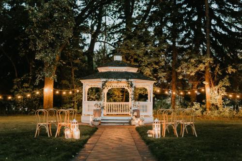 A gazeebo decorated with lights for an outdoor summer wedding